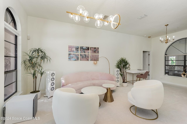 living room featuring light colored carpet and a notable chandelier