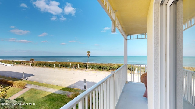 balcony with a view of the beach and a water view