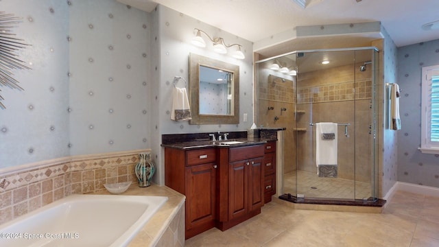 bathroom featuring tile patterned flooring, vanity, and shower with separate bathtub