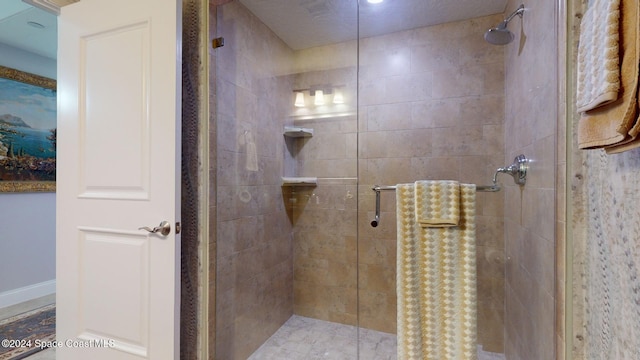 bathroom with a shower with door