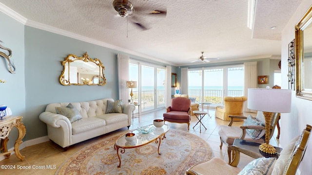 living room featuring light tile patterned flooring, ceiling fan, a water view, and a healthy amount of sunlight