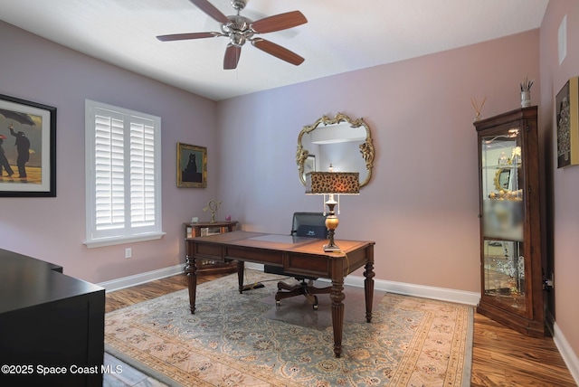 home office with ceiling fan and hardwood / wood-style floors