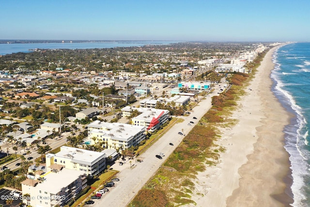 aerial view with a water view and a beach view