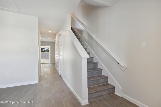 stairway with hardwood / wood-style floors