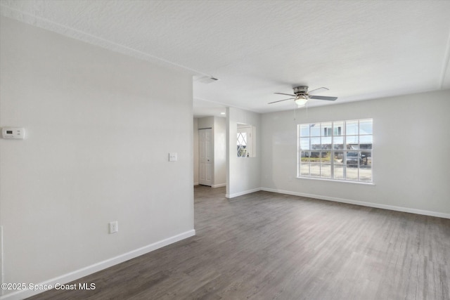 unfurnished room featuring ceiling fan, dark hardwood / wood-style flooring, and a textured ceiling