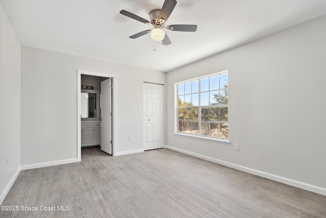 unfurnished bedroom featuring ensuite bathroom, ceiling fan, and light hardwood / wood-style flooring