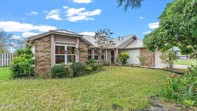 view of front of house with a front lawn and a garage