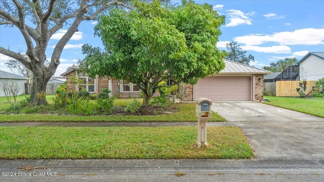 2471 Kingsmill Ave, Melbourne, FL 32934 - view of front facade with a front yard and a garage