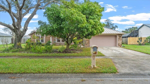 view of front facade with a front yard and a garage