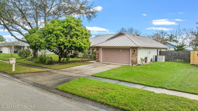 view of front of property with a garage and a front yard