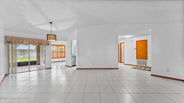 tiled empty room with vaulted ceiling