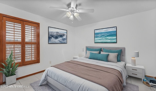 tiled bedroom featuring ceiling fan