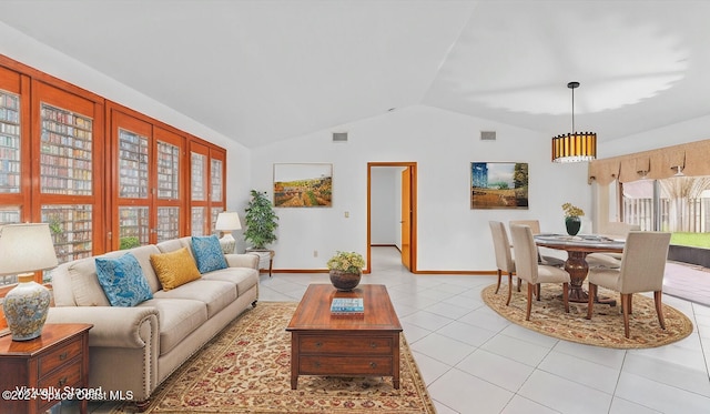 living room with light tile patterned floors and vaulted ceiling