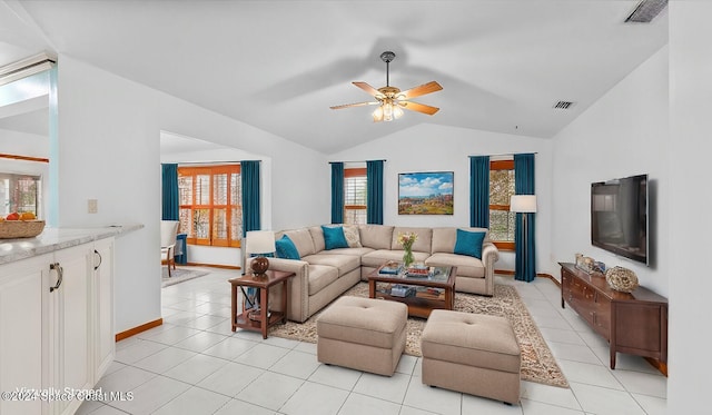 tiled living room with ceiling fan and lofted ceiling