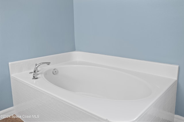 bathroom with tiled tub