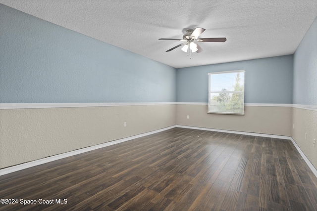 unfurnished room featuring ceiling fan, dark hardwood / wood-style flooring, and a textured ceiling