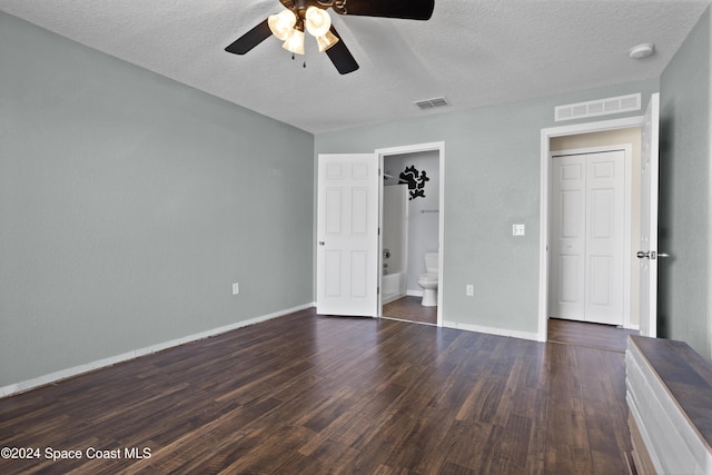 unfurnished bedroom featuring ceiling fan, dark hardwood / wood-style flooring, and a textured ceiling