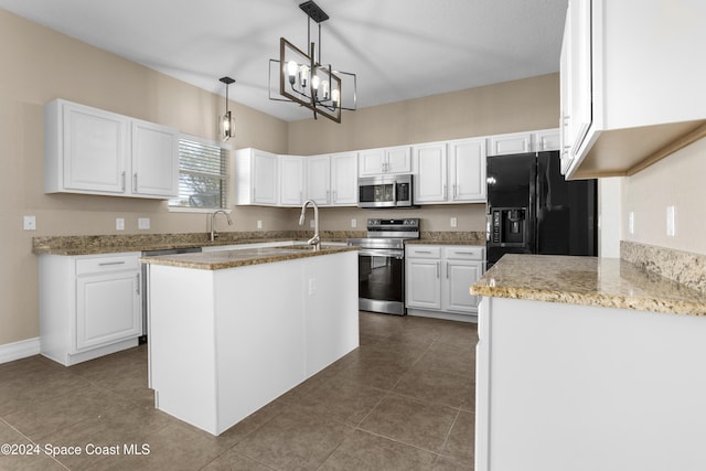 kitchen featuring stainless steel appliances, white cabinetry, hanging light fixtures, and a center island with sink