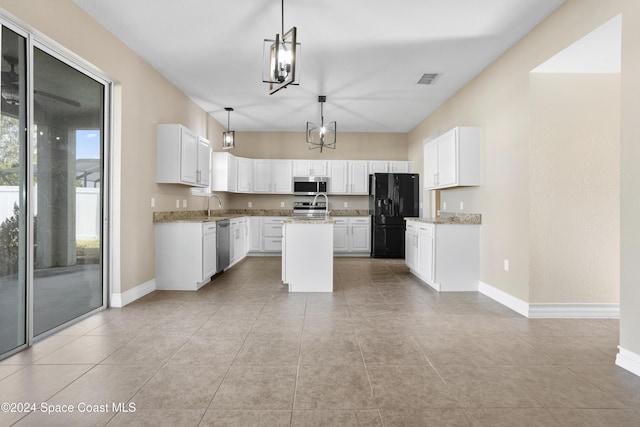 kitchen featuring white cabinetry, a center island, a notable chandelier, and appliances with stainless steel finishes