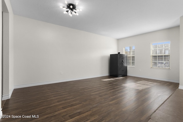 unfurnished living room with dark hardwood / wood-style floors