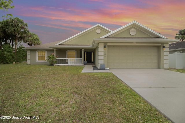 single story home with stucco siding, a front lawn, covered porch, concrete driveway, and an attached garage