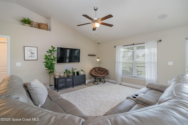 carpeted living room featuring vaulted ceiling, baseboards, and ceiling fan