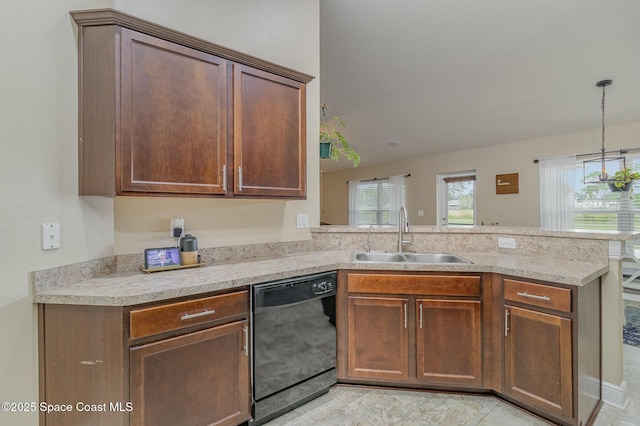 kitchen with a peninsula, light countertops, black dishwasher, and a sink