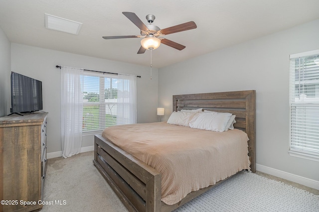 bedroom with visible vents, baseboards, light carpet, and ceiling fan