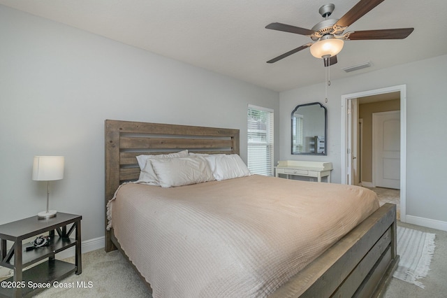 bedroom featuring visible vents, light carpet, baseboards, and ceiling fan