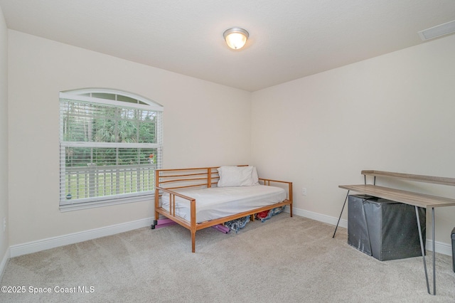 carpeted bedroom featuring visible vents and baseboards