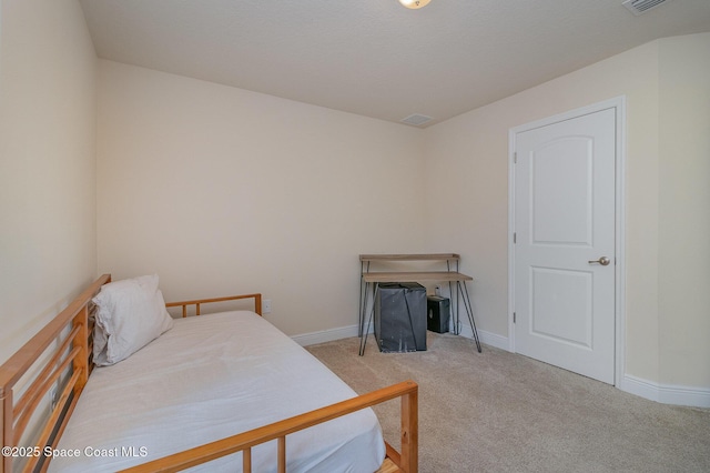 carpeted bedroom featuring visible vents and baseboards