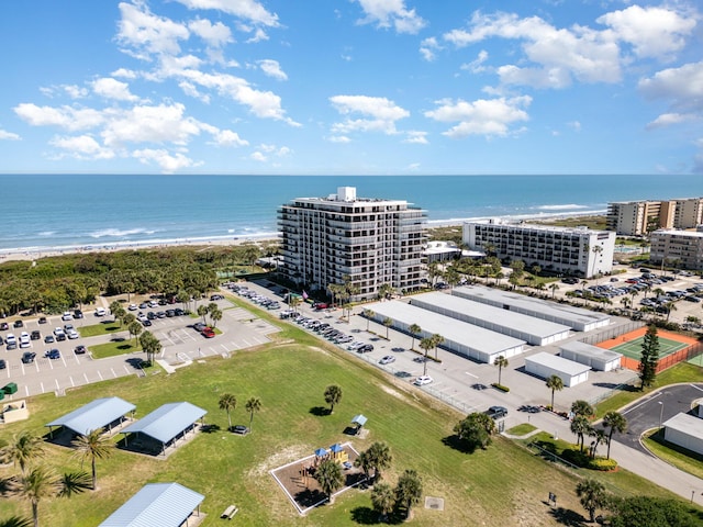 birds eye view of property with a water view and a view of the beach