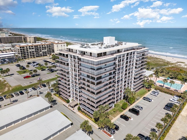 birds eye view of property with a water view and a view of the beach