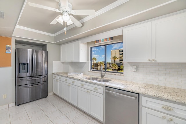 kitchen featuring ceiling fan, sink, decorative backsplash, white cabinets, and appliances with stainless steel finishes