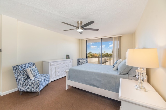 bedroom with access to exterior, ceiling fan, floor to ceiling windows, a textured ceiling, and dark carpet