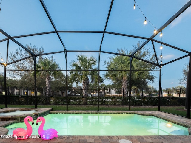 pool at dusk featuring glass enclosure