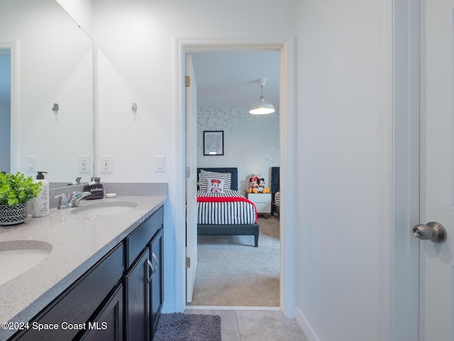 8933 Amelia Downs Trl, Kissimmee, FL 34747 - ensuite bathroom featuring double vanity and tile patterned floors