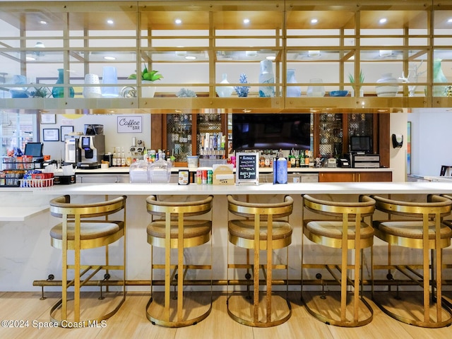 bar featuring light hardwood / wood-style floors