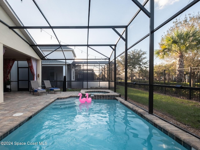 view of pool featuring glass enclosure, an in ground hot tub, and a patio