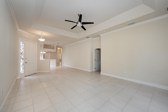 unfurnished room with a tray ceiling, ceiling fan, and crown molding