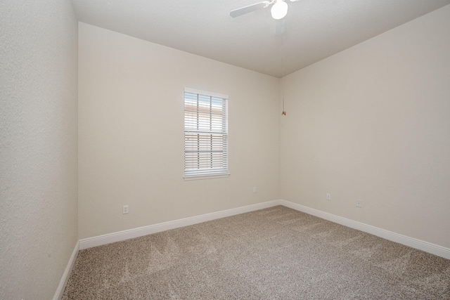 empty room with ceiling fan and carpet