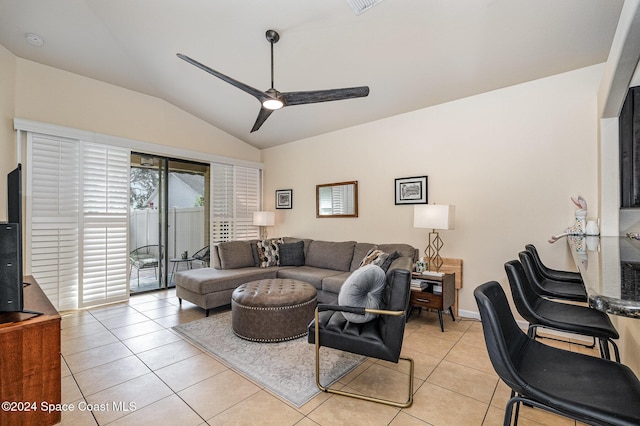 living room featuring ceiling fan, light tile patterned floors, and vaulted ceiling