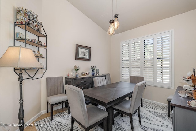 dining room featuring lofted ceiling