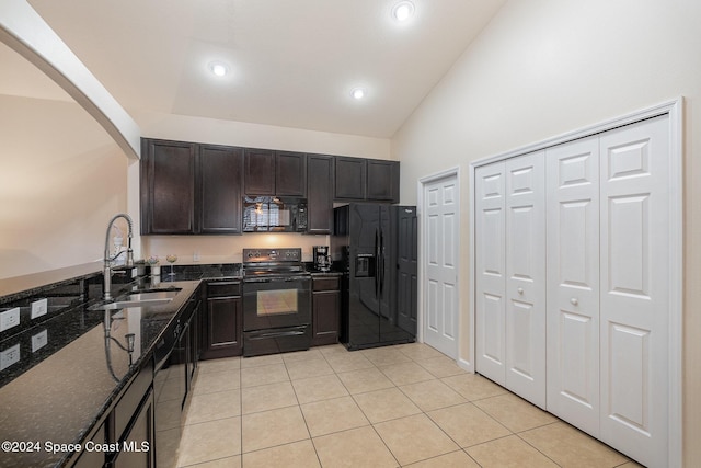 kitchen with high vaulted ceiling, dark stone counters, black appliances, sink, and dark brown cabinets