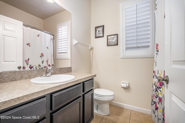 bathroom featuring tile patterned floors, vanity, and toilet