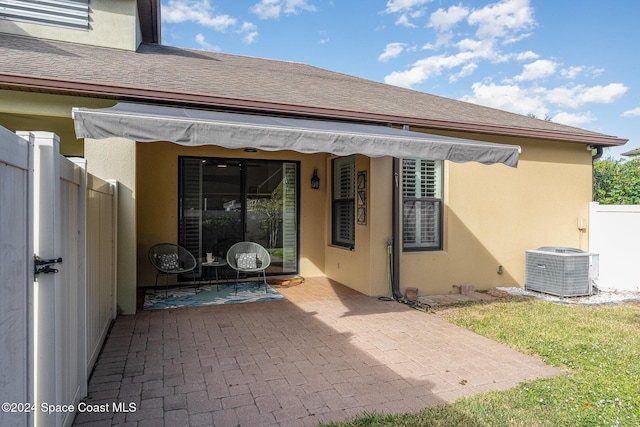 rear view of house featuring a patio area and cooling unit