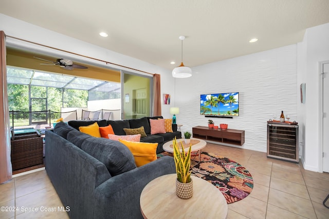 tiled living room with ceiling fan and wine cooler