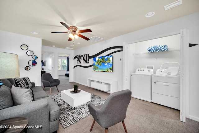 carpeted living room with washing machine and dryer and ceiling fan