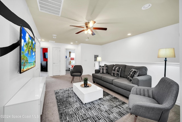 carpeted living room featuring ceiling fan