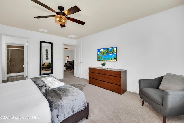 bedroom with ensuite bath, ceiling fan, and light carpet